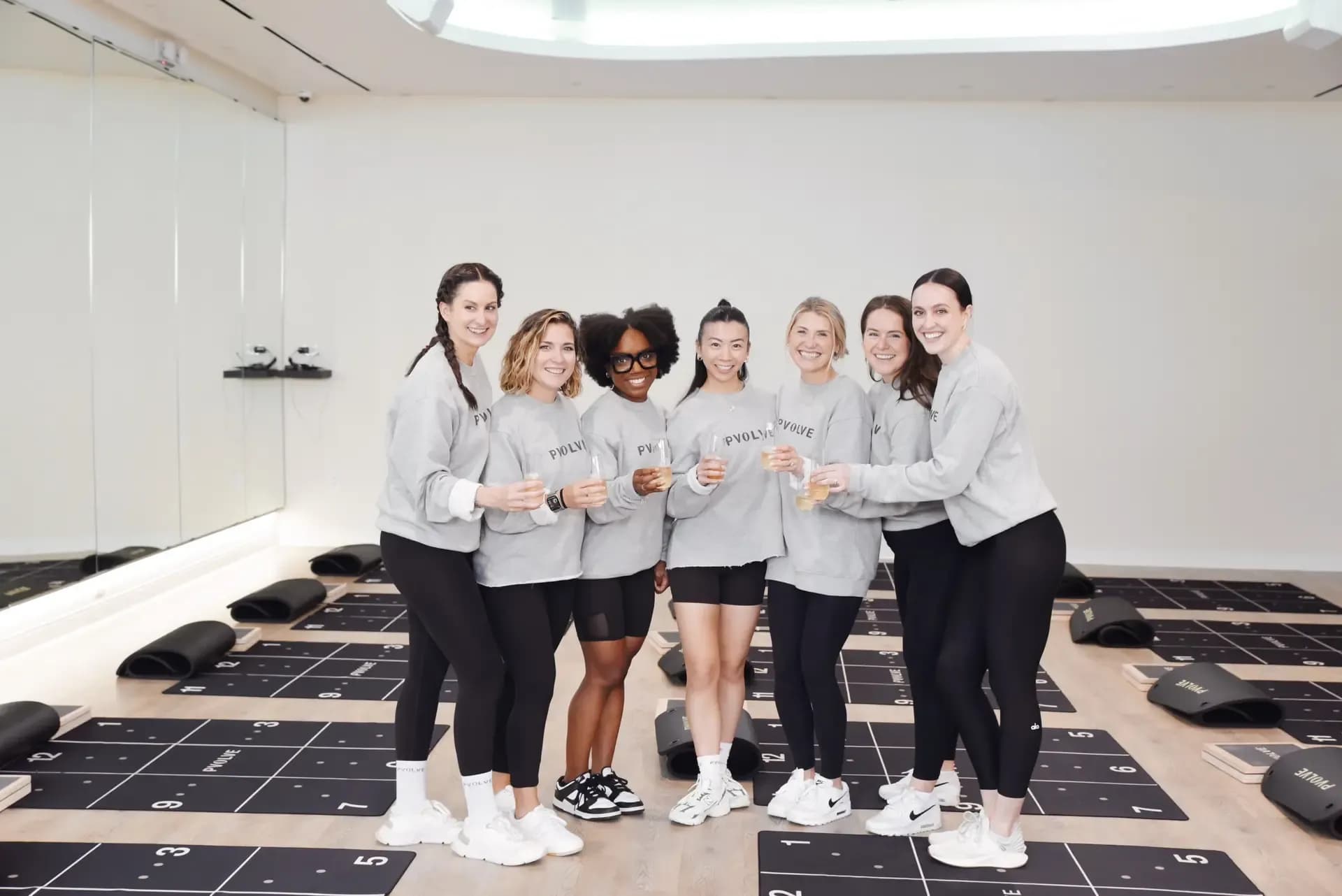 Pvolve franchise team members standing together in a fitness studio