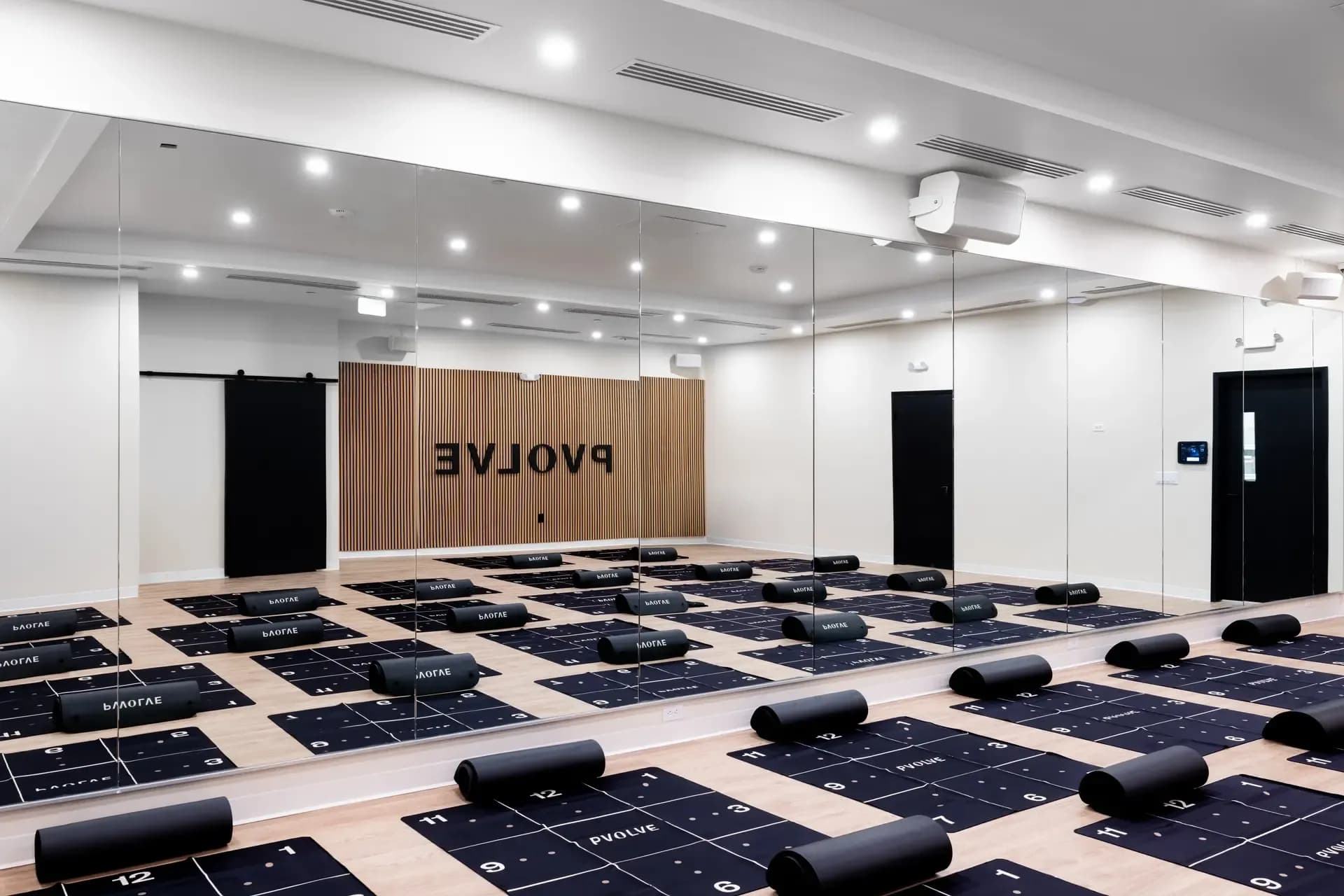Empty Pvolve studio with mats and fitness equipment set up for a class